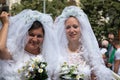 Two brides participating in Prague Pride - a big gay & lesbian p