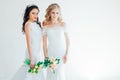 Two brides in white wedding gowns flowers Royalty Free Stock Photo