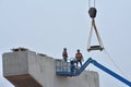 Two bridge construction workers wait on bridge parts Royalty Free Stock Photo