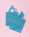 Two bright blue gift bags on a pink background Royalty Free Stock Photo