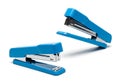 Two bright blue staplers on a white background Royalty Free Stock Photo