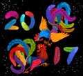 Two bright colorful rooster fighting. Lettering 2017 made of feathers. Drawing Chinese symbol of the New Year.