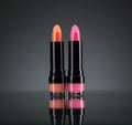 Two bright lipsticks on a black Royalty Free Stock Photo