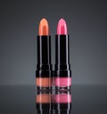 Two bright lipsticks on a black Royalty Free Stock Photo