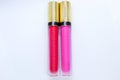 Two bright matte lipsticks on a white background. Red lipstick, pink lipstick. Women's makeup. Bright solutions for women