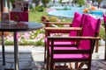 Two bright purple chairs in a row and table at the cafe Royalty Free Stock Photo