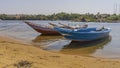 Two brightly painted wooden boats are tied up at the river bank. Royalty Free Stock Photo