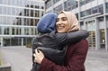 Two British Muslim Women Friends Meeting Outside Office