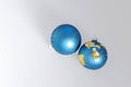 Two broken blue Christmas balls on white background as a symbol of shattered hopes, loss, disappointment Royalty Free Stock Photo