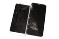 Two broken phones of white and black on a white background. cracked touchscreen glass of the touch screen isolate