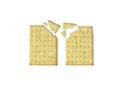 Two broken rectangular crackers with visible crumbs on a rustic wooden table, showing texture detail and natural light from above. Royalty Free Stock Photo