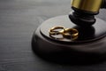 Two broken rings and hammer of a judge. Divorce concept Royalty Free Stock Photo