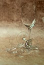 Two broken wine glasses on a light sand background 3 Royalty Free Stock Photo