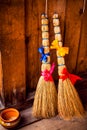 Two brooms with a bow tie and butterflies on a background