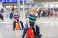 Two brother boys going on vacations trip at airport Royalty Free Stock Photo