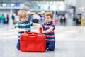 Two brother boys going on vacations trip at airport Royalty Free Stock Photo