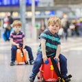 Two brother boys going on vacations trip at airport Royalty Free Stock Photo