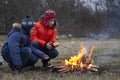 Two brother roasting hotdogs on sticks at bonfire. Children having fun at autumn camp fire. Camping kids in fall forest Royalty Free Stock Photo