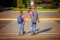 Two brothers with backpack walking, holding on warm day on the