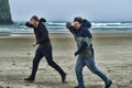 Two young men on a windy beach