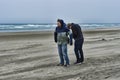 Two young men on a windy beach