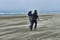 Two young men on a windy beach