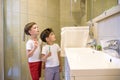 Two brothers brush my teeth in the bathroom.The beginning of a new day Royalty Free Stock Photo