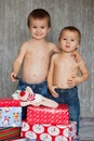 Two brothers with chickenpox on Christmas, happily looking at xmas presents Royalty Free Stock Photo