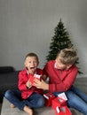 Children near Christmas tree