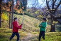 Two brothers fight with sticks. The child screams with his mouth