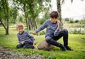 Two angry brothers fighting in park outdoors