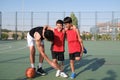 Two brothers helping to their sibling with a leg prosthesis to stretch his leg.