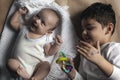 Two brothers lying and posing. Portrait of brothers. Two months baby boy and five years small boy playing cheerfully. View from Royalty Free Stock Photo