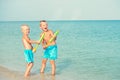 Two brothers play on the beach with water pistols. Summer time. Royalty Free Stock Photo