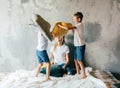 Two brothers play on the bed and fight pillows Royalty Free Stock Photo