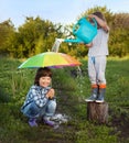 Two brothers play in rain outdoors Royalty Free Stock Photo