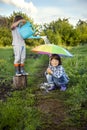 Two brothers play in rain