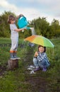 Two brothers play in rain outdoors Royalty Free Stock Photo