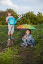 Two brothers play in rain outdoors Royalty Free Stock Photo