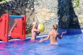 Two brothers playing with ball in swimming pool Royalty Free Stock Photo