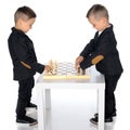 Two little boys play chess. Royalty Free Stock Photo