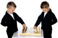 Two little boys play chess. Royalty Free Stock Photo