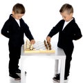 Two little boys play chess. Royalty Free Stock Photo