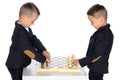 Two little boys play chess. Royalty Free Stock Photo