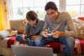 Two Brothers Playing Computer Games at Christmas Time Royalty Free Stock Photo