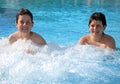 Two brothers playing in the pool in summer Royalty Free Stock Photo