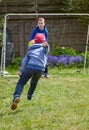 Two brothers playing soccer in the garden Royalty Free Stock Photo
