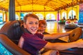 Two brothers ride electric cars in an amusement park Royalty Free Stock Photo