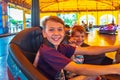 Two brothers ride electric cars in an amusement park Royalty Free Stock Photo