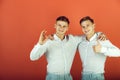 Two brothers showing thumbs up and ok gestures Royalty Free Stock Photo